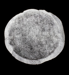 Single teabag against black