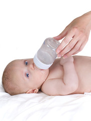 feeding of child from a vial, isolated on white