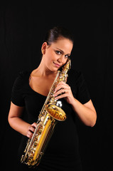 Obraz premium Young woman with saxophone