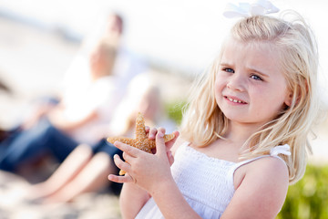 Adorable Little Blonde Girl with Starfish