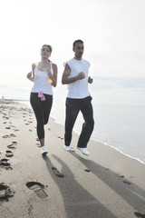 couple jogging on the beach