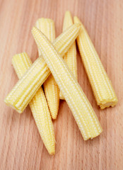 Baby corn on kitchen chopping board