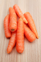 Baby carrots on kitchen chopping board