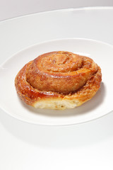 Cinnamon roll on white plate