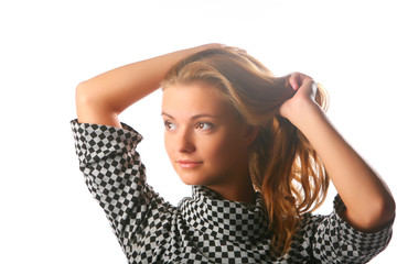 Fototapeta premium Blonde girl in a checkered dress on a white background