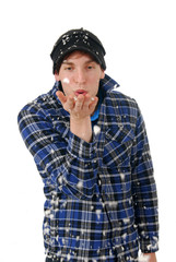 Young man blowing snow flakes
