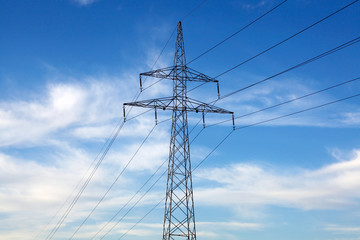 Electricity pylon and power lines on blue sky