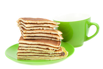 Pancakes on a plate and cup isolated on white