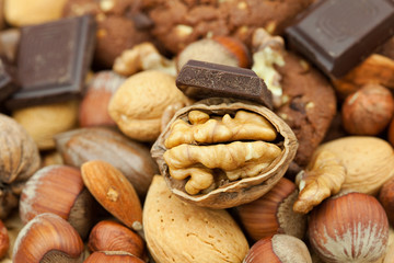 oatmeal cookies, chocolate and nuts on a wicker mat