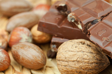 bar of chocolate and nuts on a wicker mat