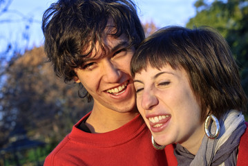 Fototapeta premium Young couple in their twenties laughing outdoors