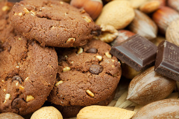 oatmeal cookies, chocolate and nuts on a wicker mat
