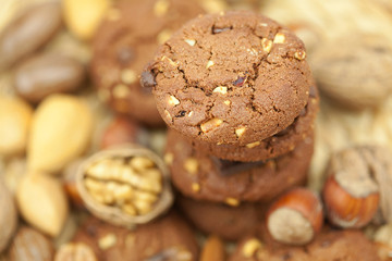 oatmeal cookies, chocolate and nuts on a wicker mat