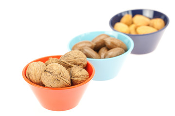 nuts in bowls isolated on white
