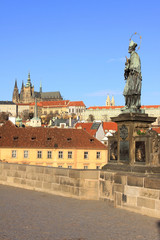 Fototapeta na wymiar Baroque Statue on the Prague Charles Bridge with the Castle
