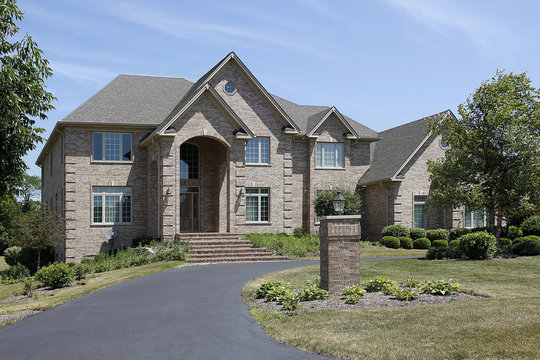 Large brick home with arched entry