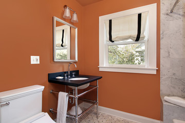 Powder room with orange walls