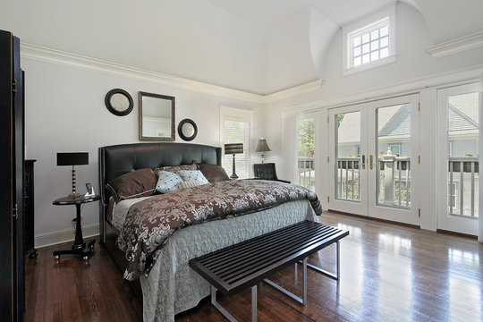 Master bedroom in luxury home with balcony