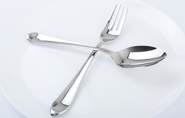 Dinner plate, spoon and fork.