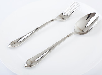 Dinner plate, spoon and fork.