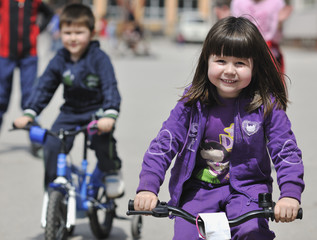 happy childrens group learning to drive bicycle