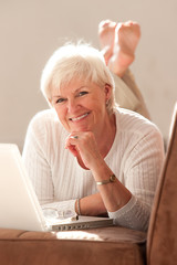 Fototapeta premium Attractive woman in her fifties with laptop