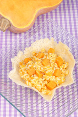 Risotto with pumpkin in a cheese basket