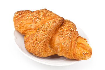 Croissant with sesame seeds on a plate