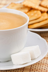Breakfast: a cup of  coffee with a lump sugar and crackers
