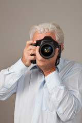 Mature photographer taking picture.