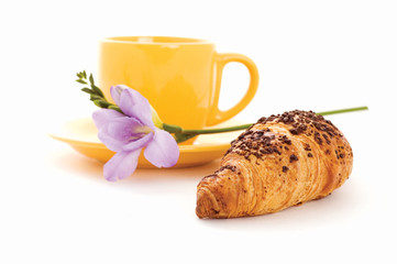 croissant, cup of coffee and flower