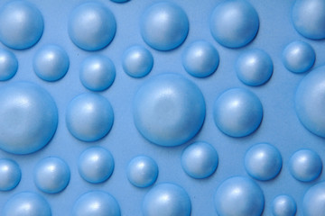 The background is blue in the form of balls