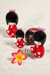 Three Japanese doll on paper background