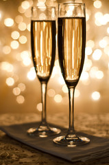 Glass of champagne against golden background