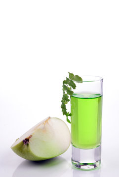 Shot of green cocktail on a white background