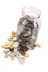 coins spilling from a money jar