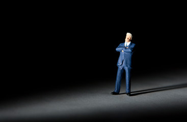 Fototapeta na wymiar Miniature figurine of successful businessman