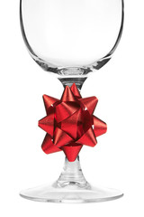 Empty wine glass with red bow