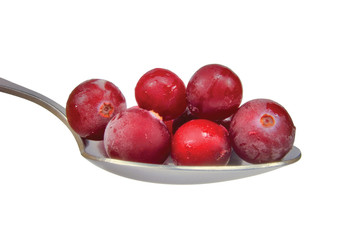 Spoonful of fresh frozen cranberries isolated on white, macro