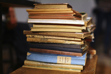 Pile of old literature books stacked on the shelf