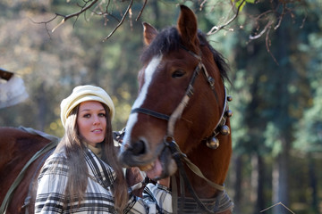 Fototapeta premium Portrait of beautiful girl with horse in a park