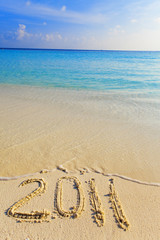 On sand at ocean edge it is written 