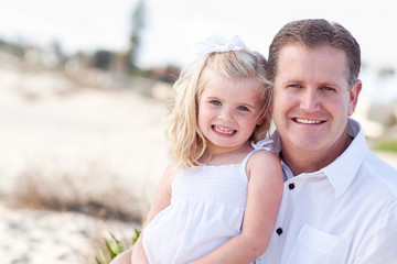 Fototapeta premium Cute Daughter Cuddles up with Her at the Beach