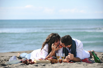 young couple enjoying  picnic on the beach
