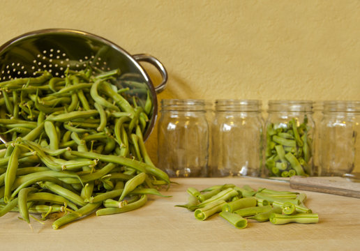Cutting green beans in preparation for canning