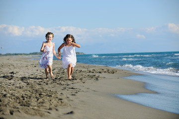 cute little girls running on beach