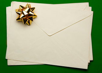 Envelope with ribbon isolated on green background