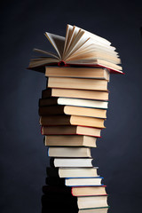 Pile of books on a black background - 27611112