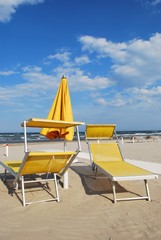 Yellow beach chairs and umbrella, Rimini, Italy