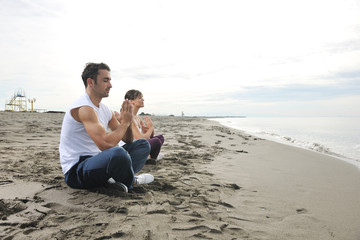 couple yoga beach